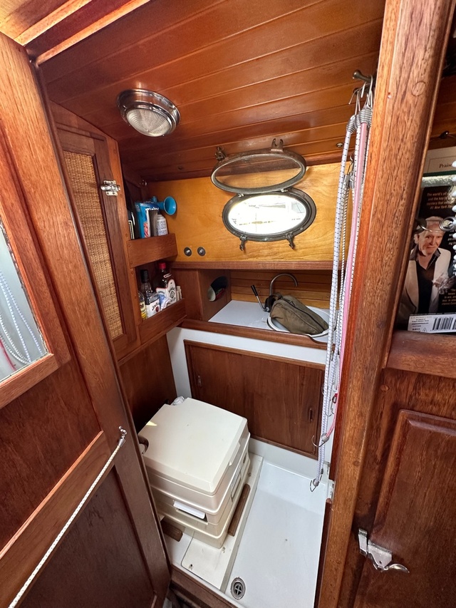 Original composting toilet in the Nor'Sea 27 head on a plain white fiberglass sole