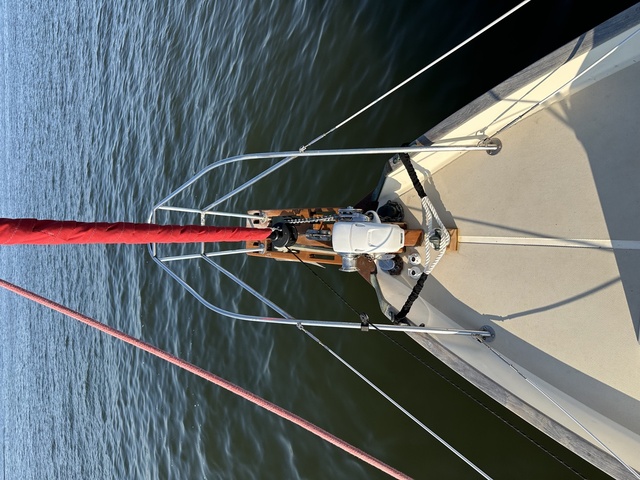 Looking down the bowsprit from the mast at anchor, Lewmar H2 windlass and teak platform visible with chain running into the water below