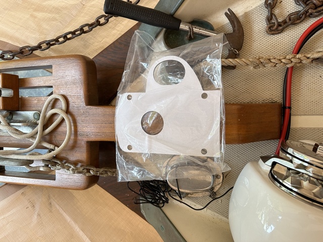 Lewmar H2 mounting gasket in packaging, showing the pentagonal shape with bolt holes and cable cutout