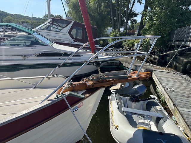 Original narrow teak bowsprit on Queen of Hearts at the dock, showing the existing anchor roller and chain arrangement