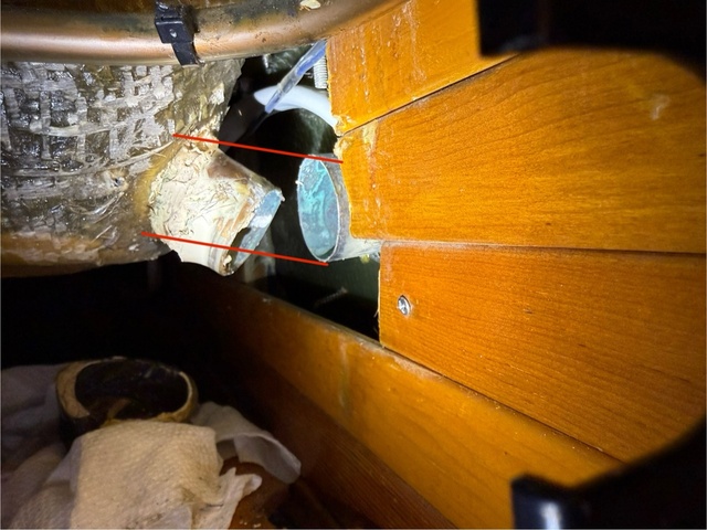 Interior view of the brass scupper connector with red lines annotated to show the problematic low point in the original angle