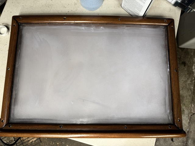 Finished aft cabin hatch with tape removed, showing the clean frosted polycarbonate panel in the teak frame